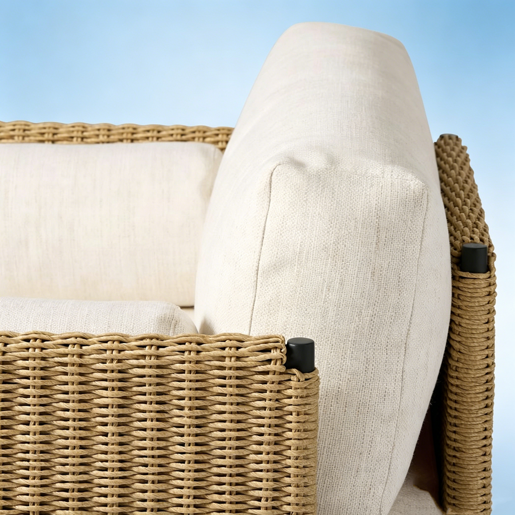 Close-up of Ventura chair handwoven wicker texture and black aluminum leg detail